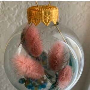 Handmade small Xmas bulb and real air dried plants and teal feathers.